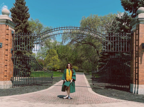 A student stands near the font gate of NDSU